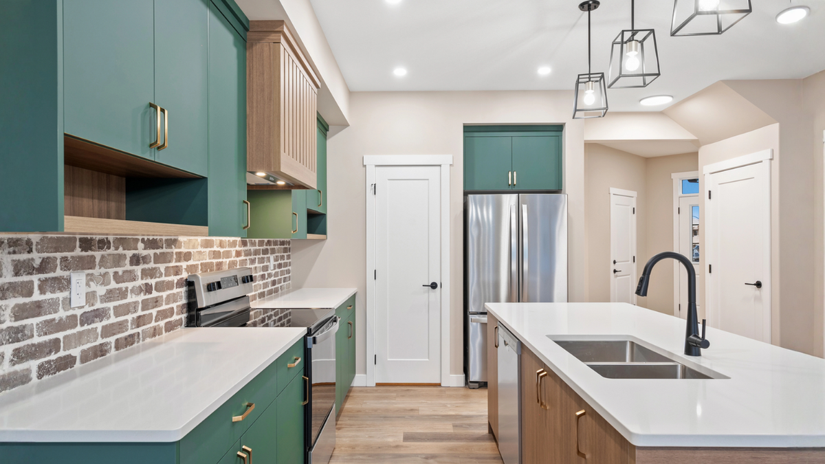 Renovated Toronto kitchen showcases modern cabinets, island, lighting, and contractor quality for 2026 upgrades.
