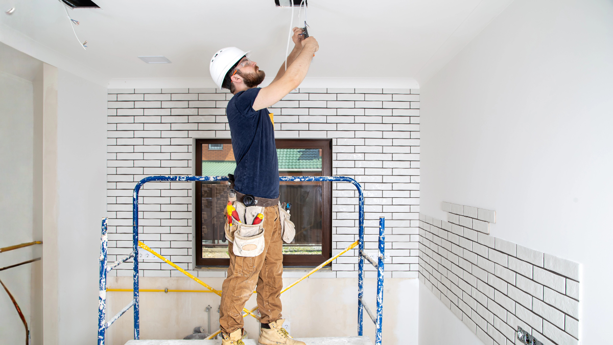Electrician working on remodeling an older rental property