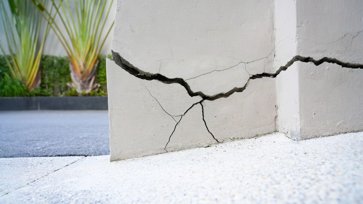 Cracked foundation wall shows subsidence damage buyers should inspect before purchasing affected house carefully and thoroughly.