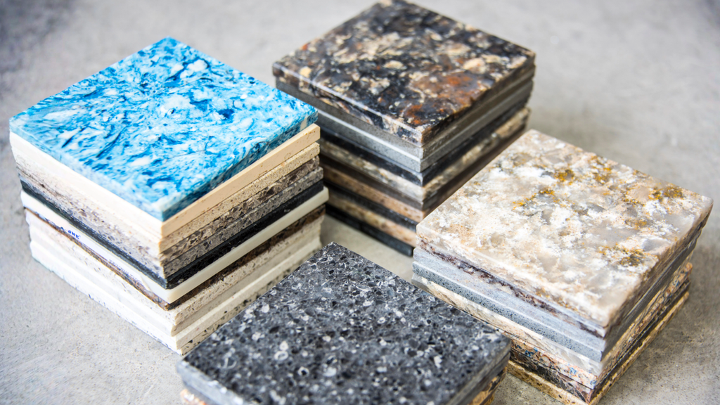 Quartz, marble, granite, and quartzite countertop samples help homeowners compare kitchen material choices and durable surfaces.
