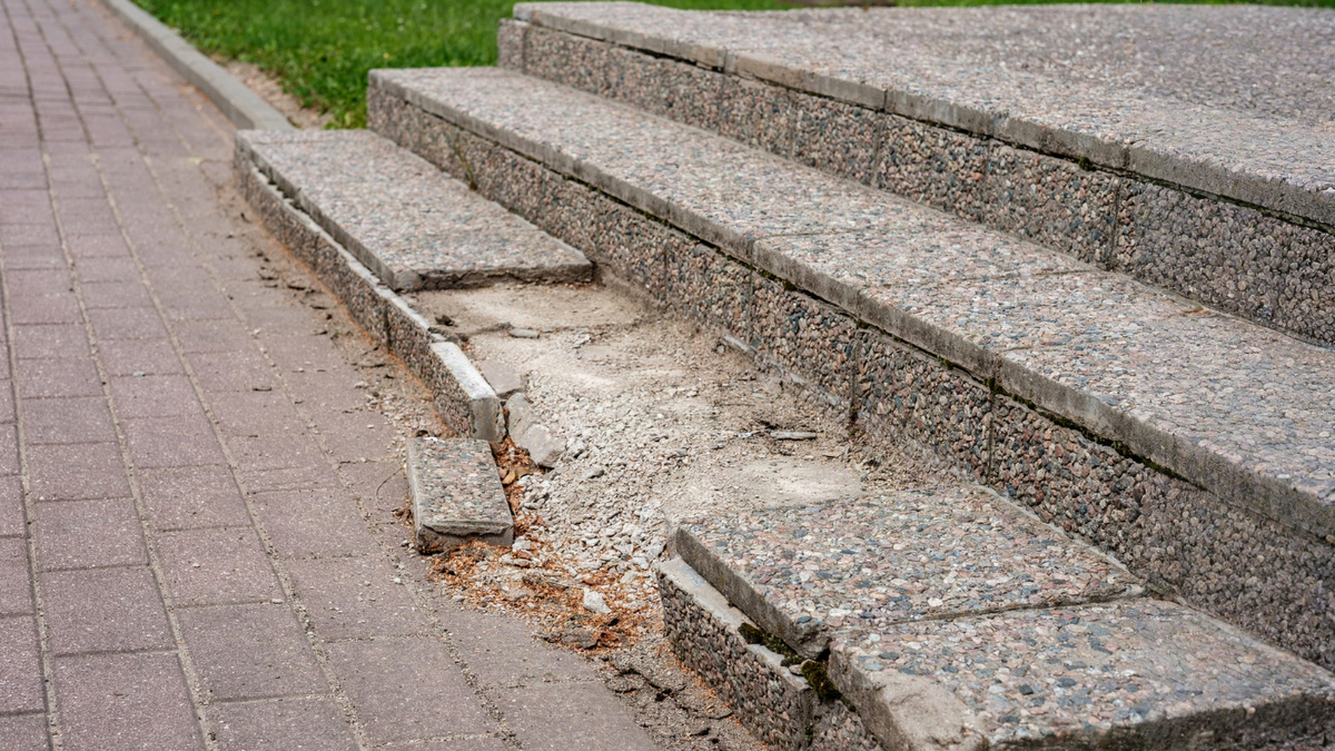 Damaged rental property stairs show slip and fall hazards causing injuries and long-term tenant impacts.