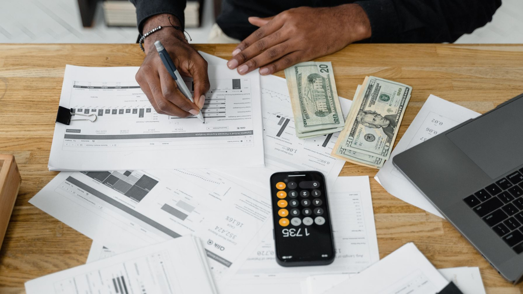California cost segregation analysis with financial documents, calculator, and cash illustrates federal deductions and state tax adjustments.
