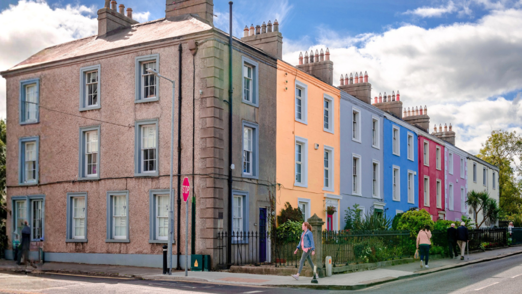 Colorful Irish row houses showing home underinsurance risks and importance of accurate property coverage valuations.