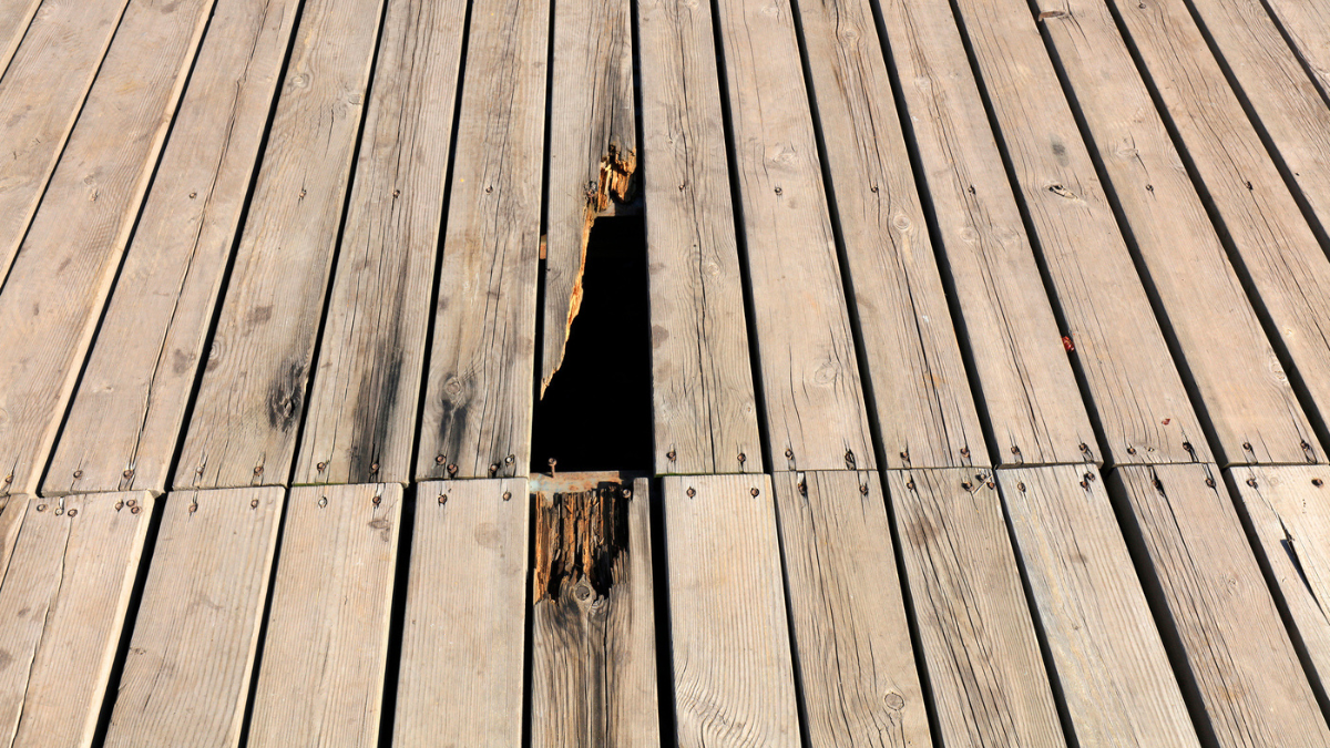 Broken wooden deck boards create injury risks and liability concerns for rental property owners and landlords.