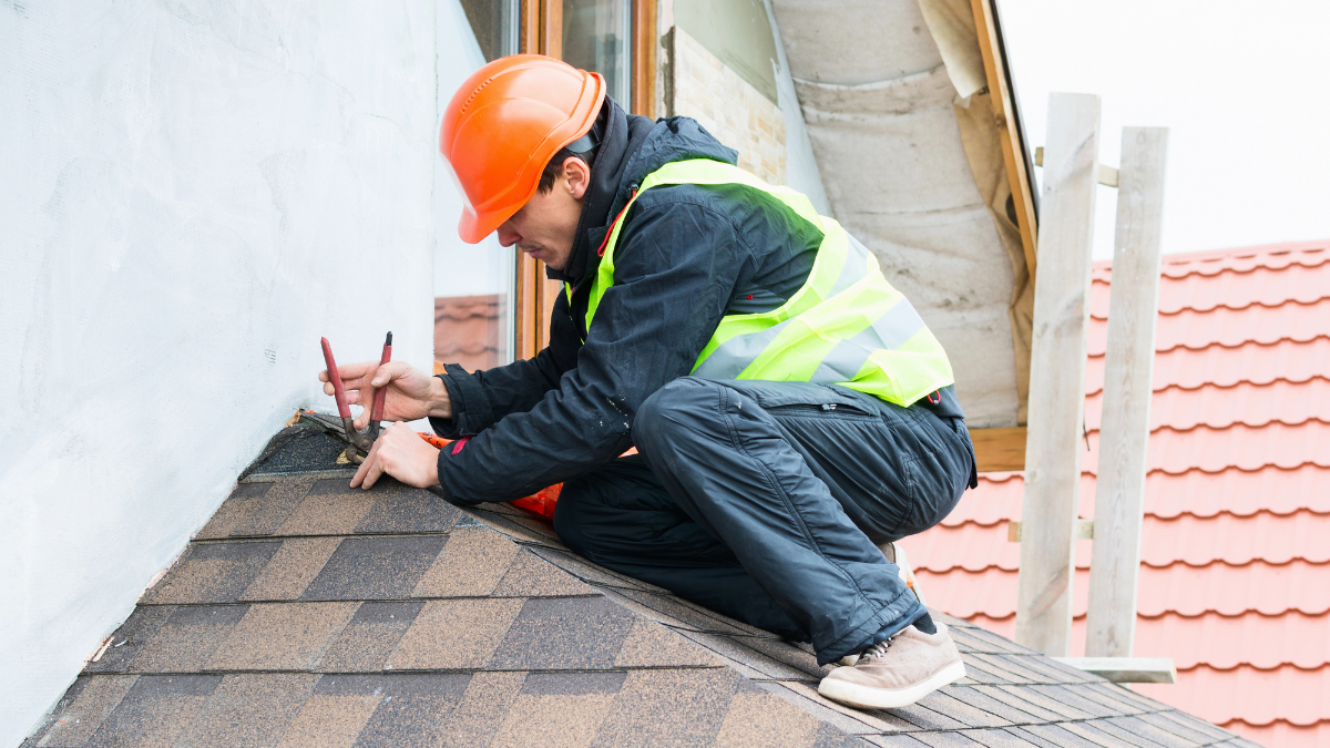 Roofing contractor inspecting for repair