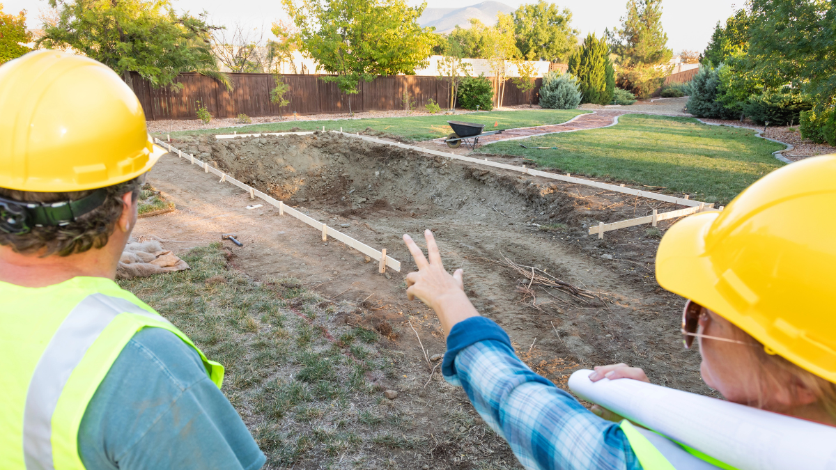 Construction workers discussing pool construction