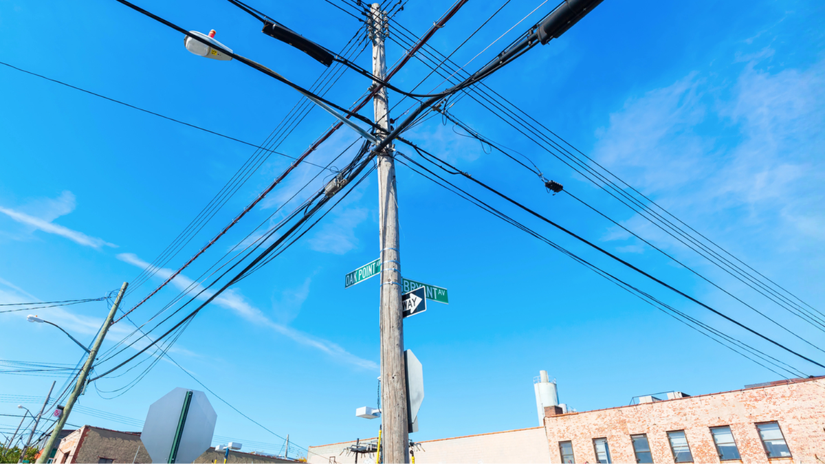 Utility power lines near rental homes highlighting ways landlords and tenants can reduce electricity bills.