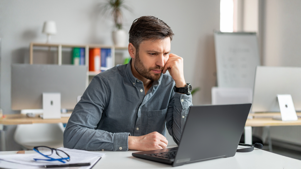 Landlord reviewing foreclosure documents online explores strategies to save rental property and protect investment flow.