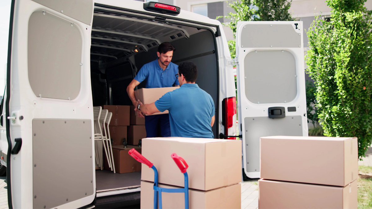 Two men moving boxes
