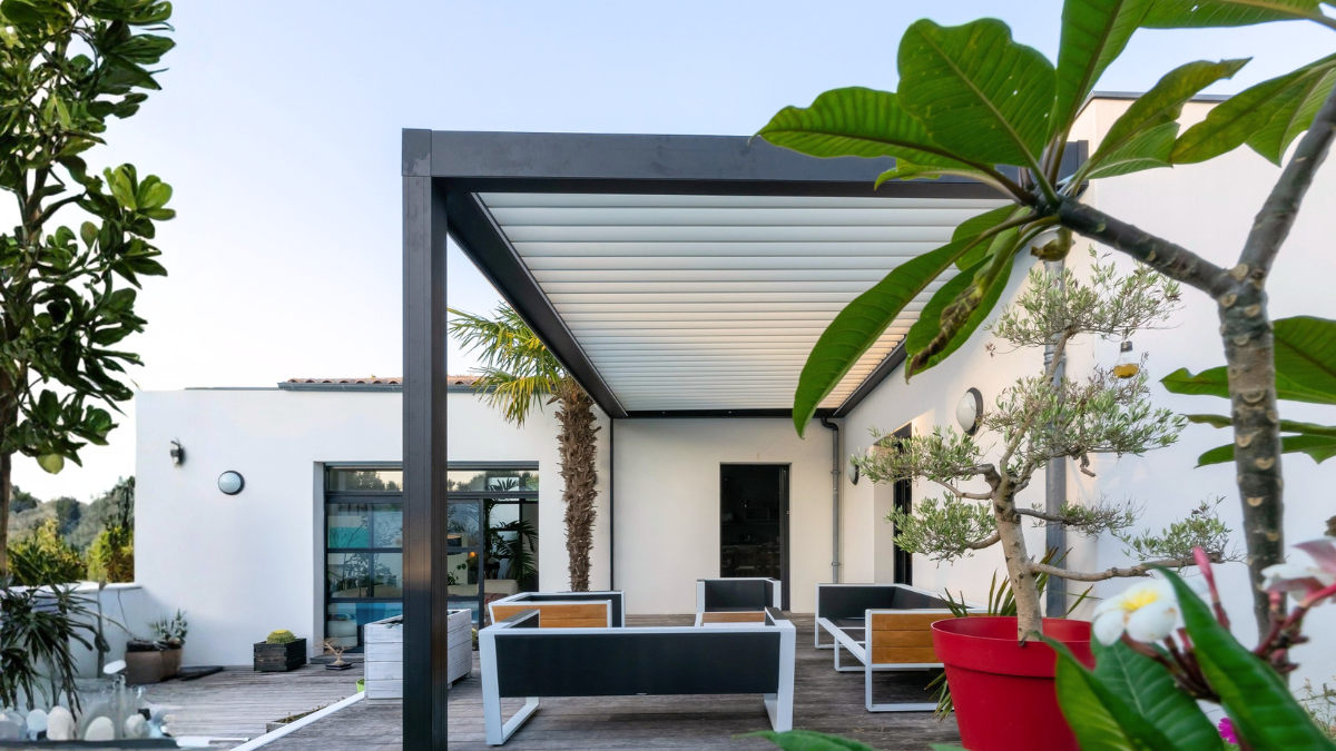 Attractive outdoor patio area with metal pergola and plants.