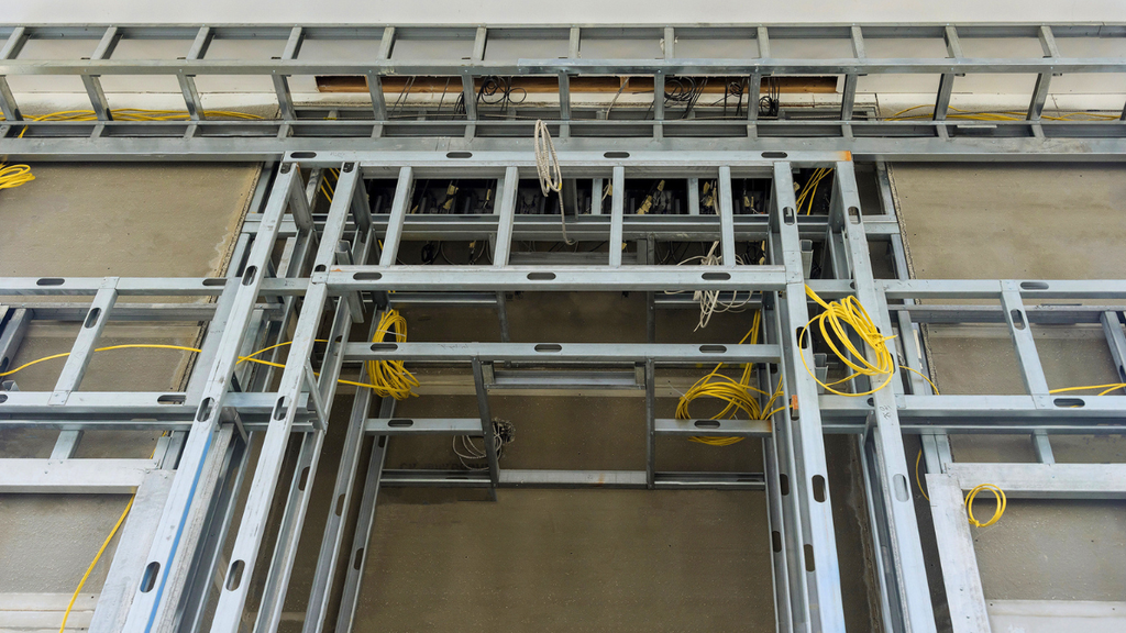Exposed structural framing and wiring show value-add property improvements requiring essential structural upgrades planning oversight.