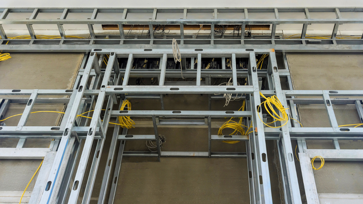 Exposed structural framing and wiring show value-add property improvements requiring essential structural upgrades planning oversight.