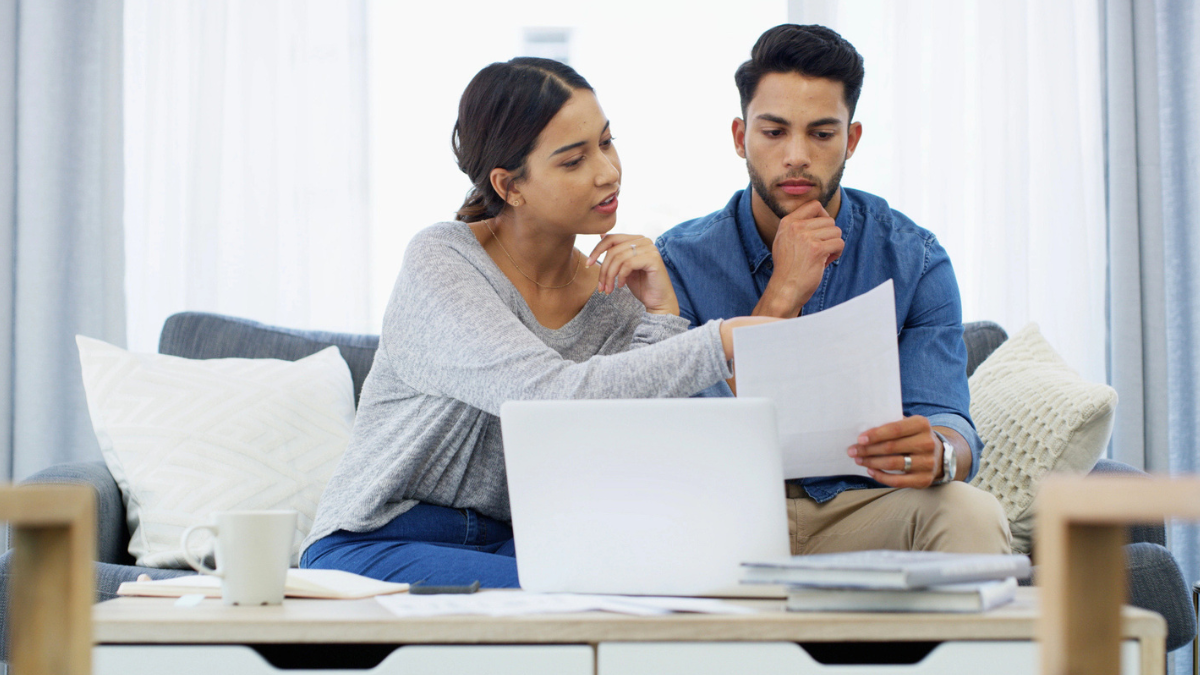 Couple reviewing offers submitted to buy their house.