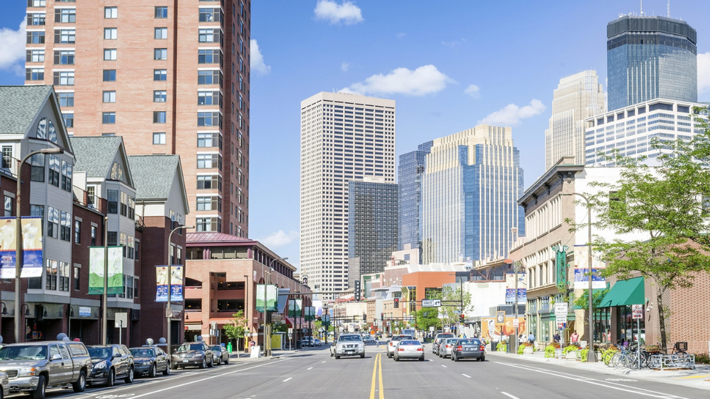 Minneapolis downtown skyline and streets illustrate neighborhoods, leases, and move-in logistics for new renters relocating.