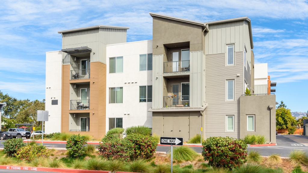 Apartment rental property exterior illustrates signs landlords may need professional property management for daily operations.