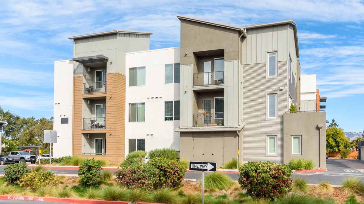 Apartment rental property exterior illustrates signs landlords may need professional property management for daily operations.