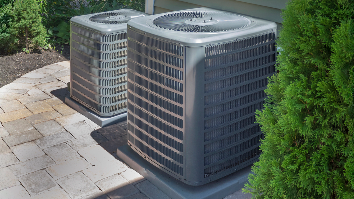 Outdoor HVAC units sized for Ozarks homes balancing humid summers, cold winters, and energy efficiency.