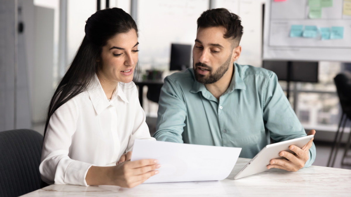 Two people reviewing tenant screening report