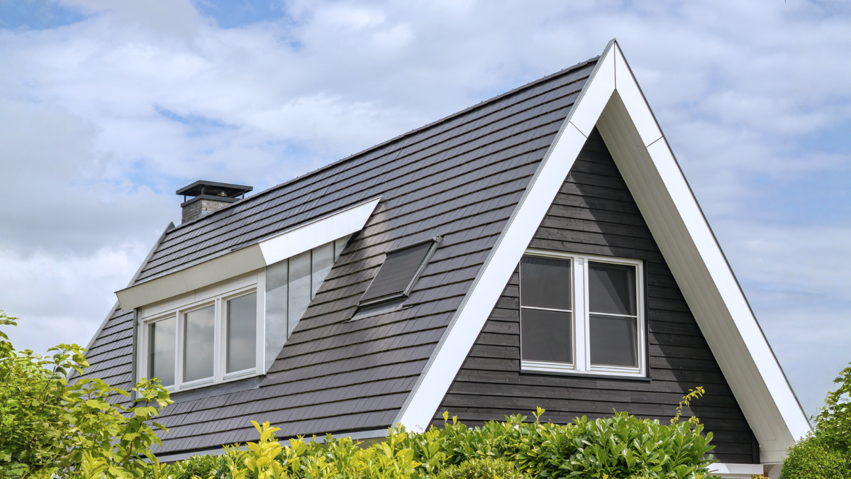 Pitched roof windows on modern home show skylight options for attic light and ventilation planning.