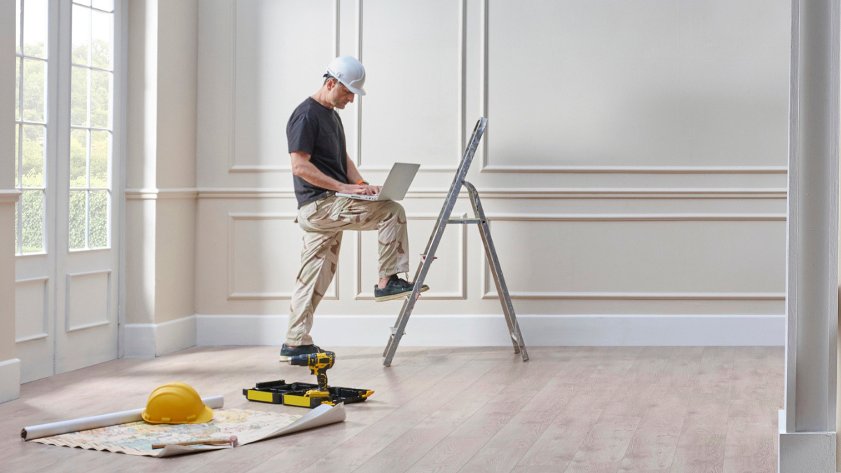 Contractor reviewing schedule in vacant rental before move-in, helping landlords avoid renovation timing delays.