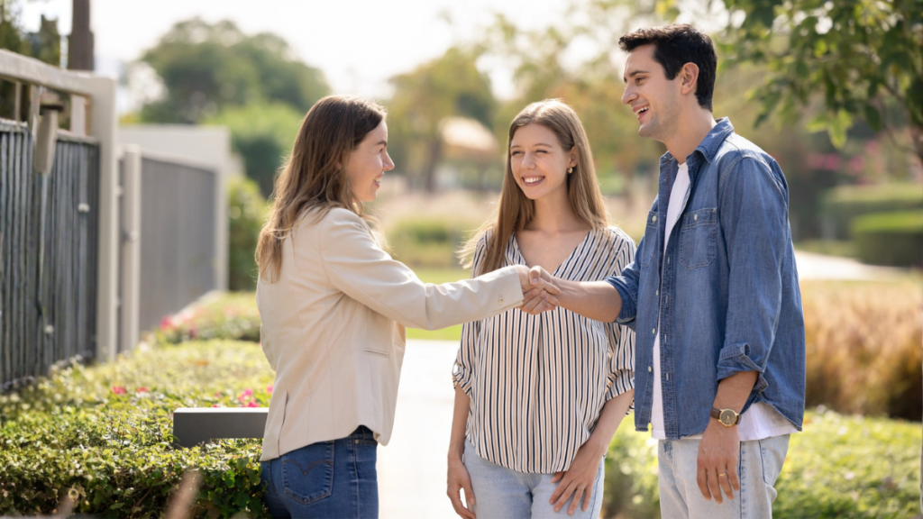 Landlord meeting with tenants outside of a rental property.