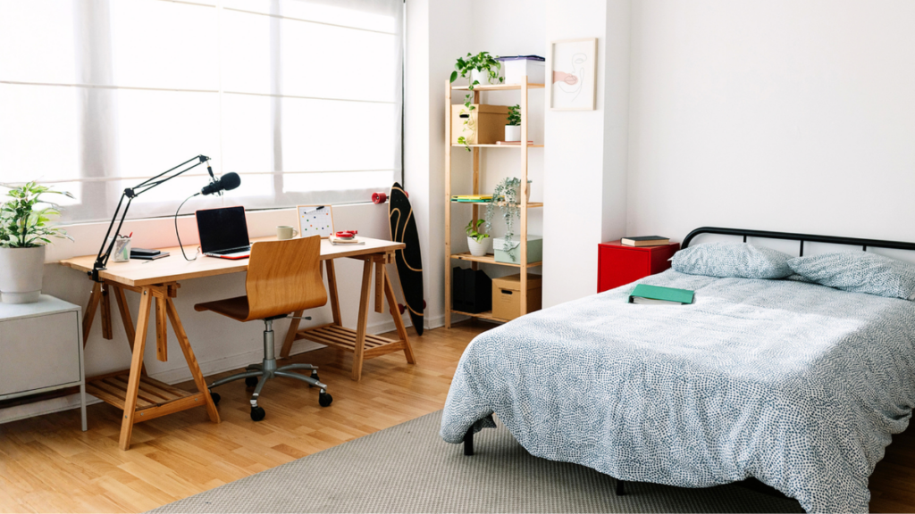 Student housing bedroom with study workspace highlights rental challenges, affordability solutions, and tenant comfort needs.