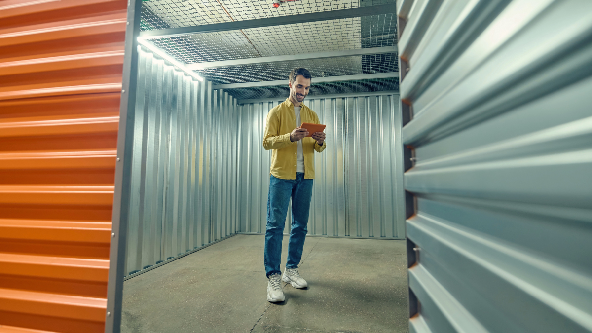 Man inside self storage unit assessing size