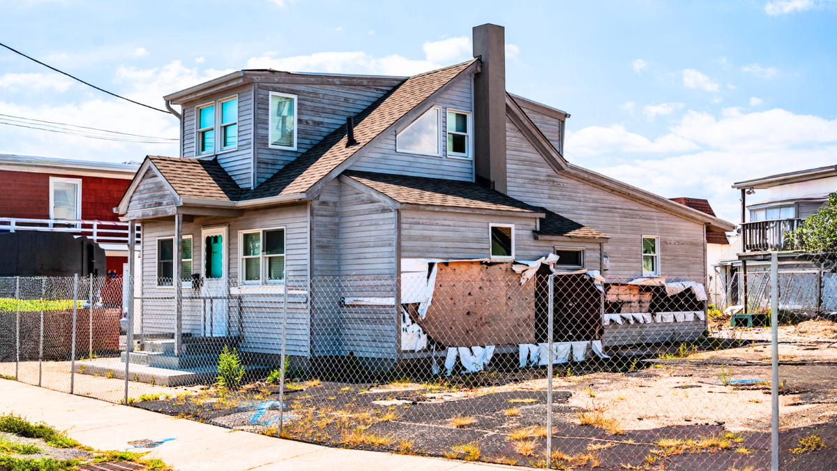 Distressed property exterior showing investors how to convert problem homes into capital for future investments.