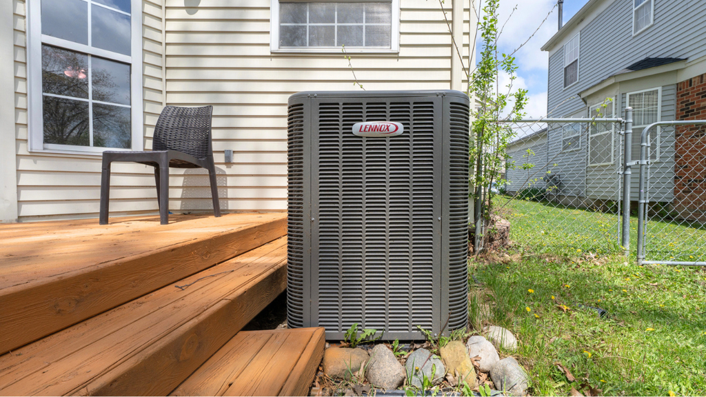 Outdoor air conditioner unit beside New Orleans home requiring annual maintenance for efficient cooling performance.