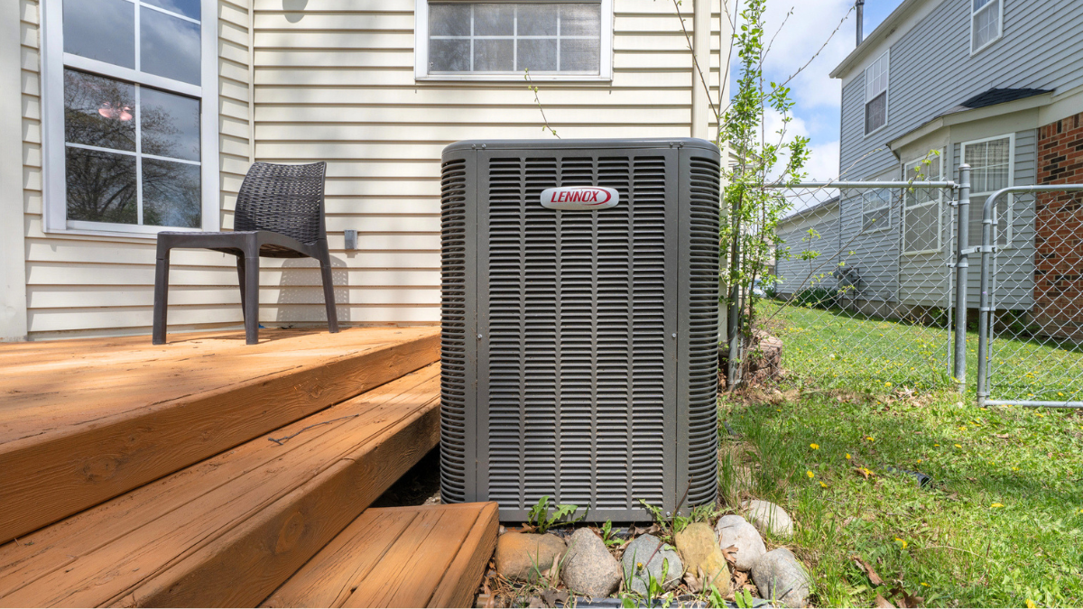Outdoor air conditioner unit beside New Orleans home requiring annual maintenance for efficient cooling performance.