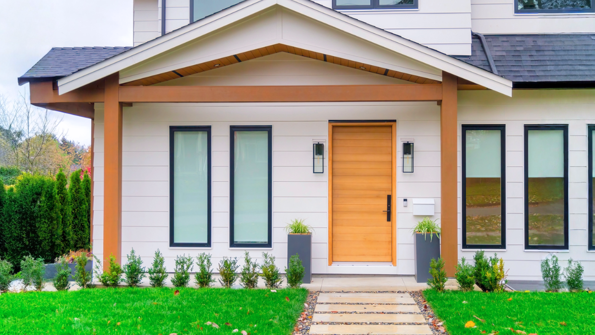 Modern rental property exterior featuring upgraded windows and door that increase curb appeal and value